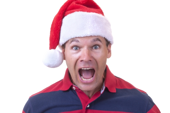 ways to prepare for and defeat holiday stress - stressed man wearing a Christmas stocking cap