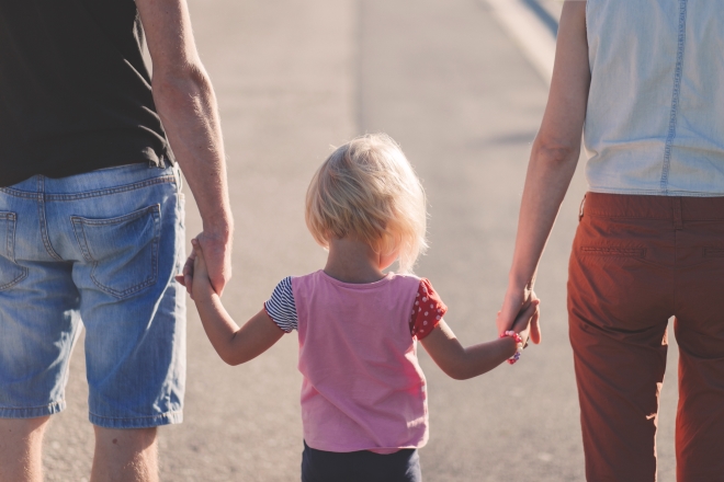 lead your children to health and wellness - stepdad and mom walking with the daugher between them