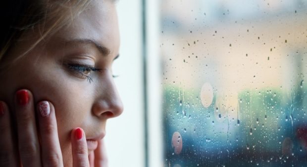 helping your teen manage anxiety & stress -Face close up portrait of young girl next to window glass