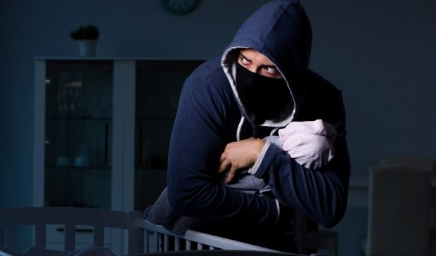 criminal stealing baby from crib