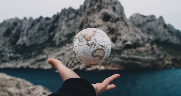 tossing world globe in air