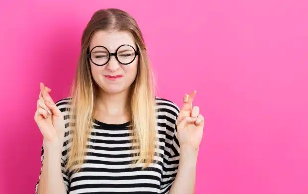 young woman wishing for good luck