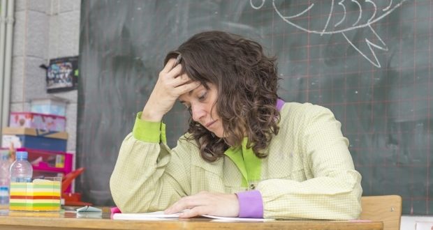 tired teacher in classroom