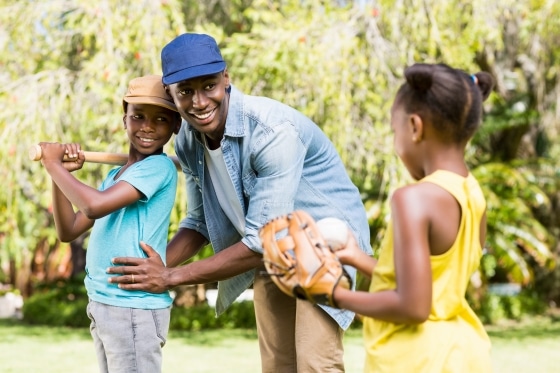 family playing baseball together