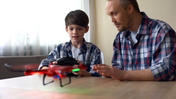 father and son playing with drone