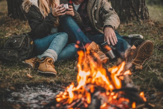 tips when buying a gift for that special someone - Couple relaxing near campfive
