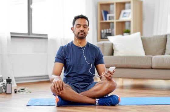 What To Include in Your Quarantine Routine - man listening to music with smartphone