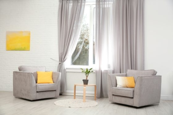 how to make your home look luxurious- sitting area with long curtains