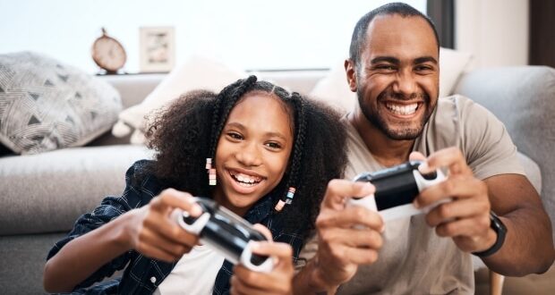 How To Build A Strong Bond With Your Teen Stepkids - Stepdad and stepdaughter playing video game