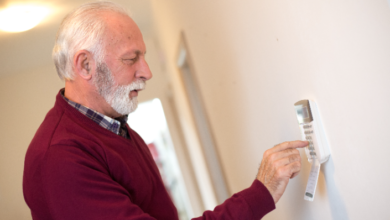 personal alarm systems for seniors - elderly man turning off his alarm.