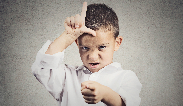 How permissive parenting leads to rude kids-Angry boy displaying loser sign