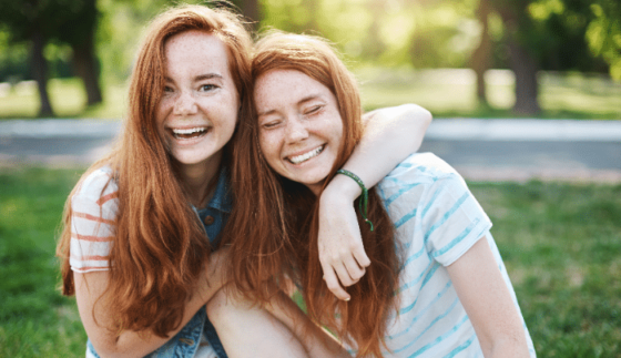 Celebrating Sisters Day - Happy sisters outdoors 