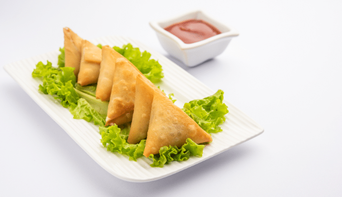 World Samosa Day - A plate of delicious looking Samosa and sauce.