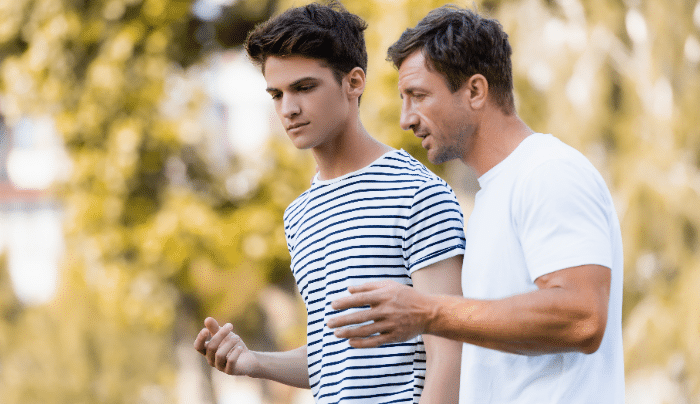 supporting teen stepchildren-stepdad speaking with teenager