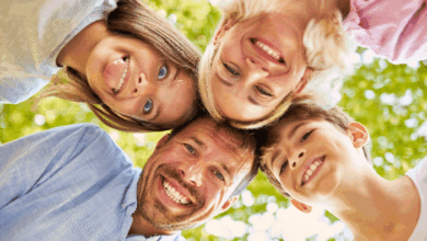 What Do You Teach Your Children By The Way You Treat Their Mother? A happy family smiling into the camera