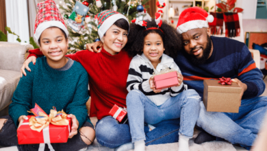 Building New Traditions In A Blended Family: A Stepfather’s Guide To Navigating Christmas-Happy blended family of four bonding sitting on the floor together with Christmas decorations in the living room.