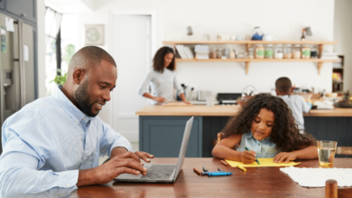 Balancing Remote Work And Parenting - dad working from him while kids are studying