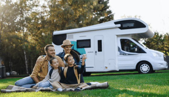 Importance of buying from trusted caravan dealers - a happy family in front of a caravan