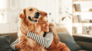 National Dog Day- dog owner happily hugging her pet