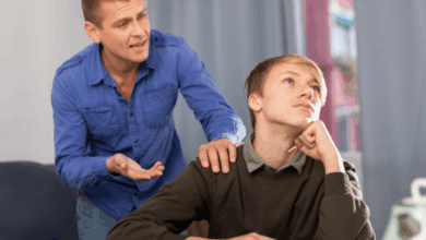 Why Do Kids Hate Their Stepparents-Young unhappy teenage boy ignoring his stepdad, man trying conversate with boy.