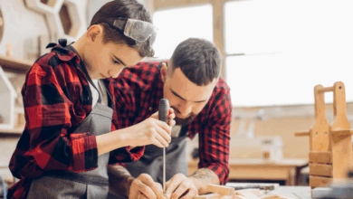 best hobbies for dads-Stepdad and stepson together at home standing at table dad holding screwdriver explaining boy working process