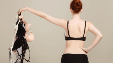 Finding the perfect sleep bra - woman holding bras while wearing a simple black bra and underwear