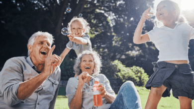 step-grandparents in blended families-Step grandparents and step grandkids blowing bubbles in the park.